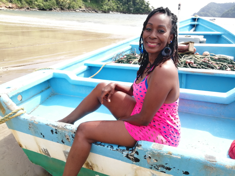 Woman sitting in pirogue boat at Maracas Beach Tour, Trinidad