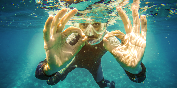 scuba diver giving the A Ok sign with both hands