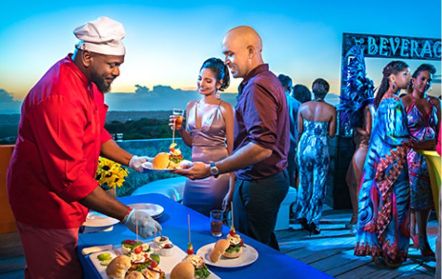 Certainly one of the things to do in the Caribbean is enjoy the Barbados Food and Rum Festival where this couple is being served a dish by a chef