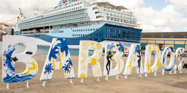 Cruise ships in port of Bridgetown, Barbados with welcome sign along waterfront.