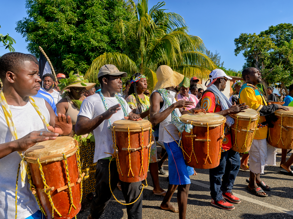 One of the things to do in the Caribbean is enjoy the Belizean celebrations of the Garifuna as shown here by men drumming as they walk in procession