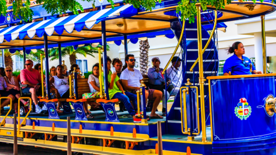 A group of tourists on a tram car in Aruba