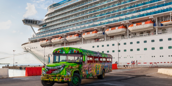 A Princess ship docked in Oranjestad at December 01, 2011. A colorful tour bus waiting for the next group of tourists for a fun island tour