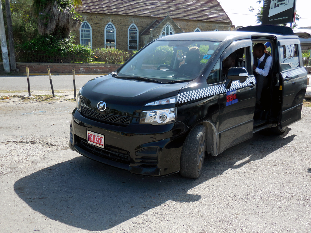 Tourists being dropped by taxi for a guided tour in Barbados